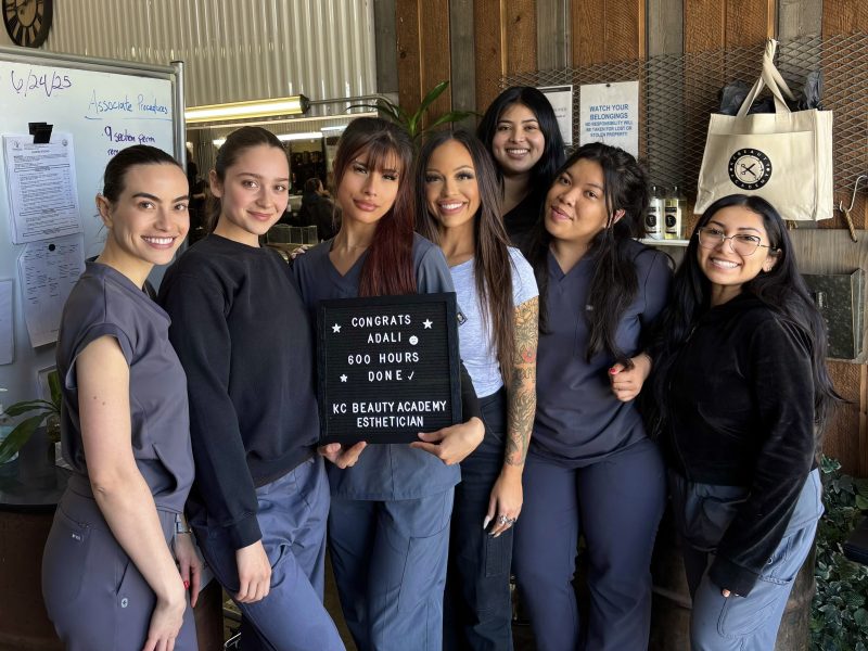 KC Beauty Academy esthetician students celebrating a classmate’s graduation after 600 hours