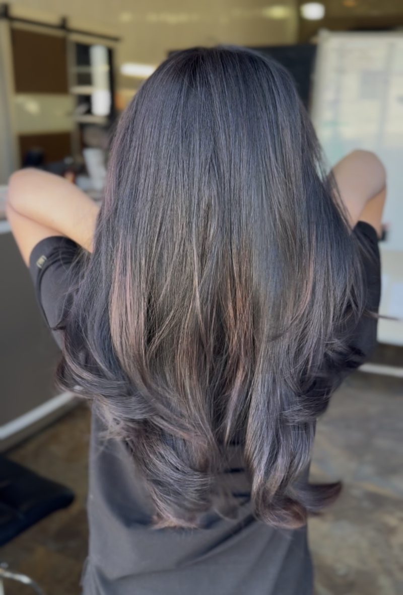 Long layered haircut with soft dimensional color at KC Beauty Academy